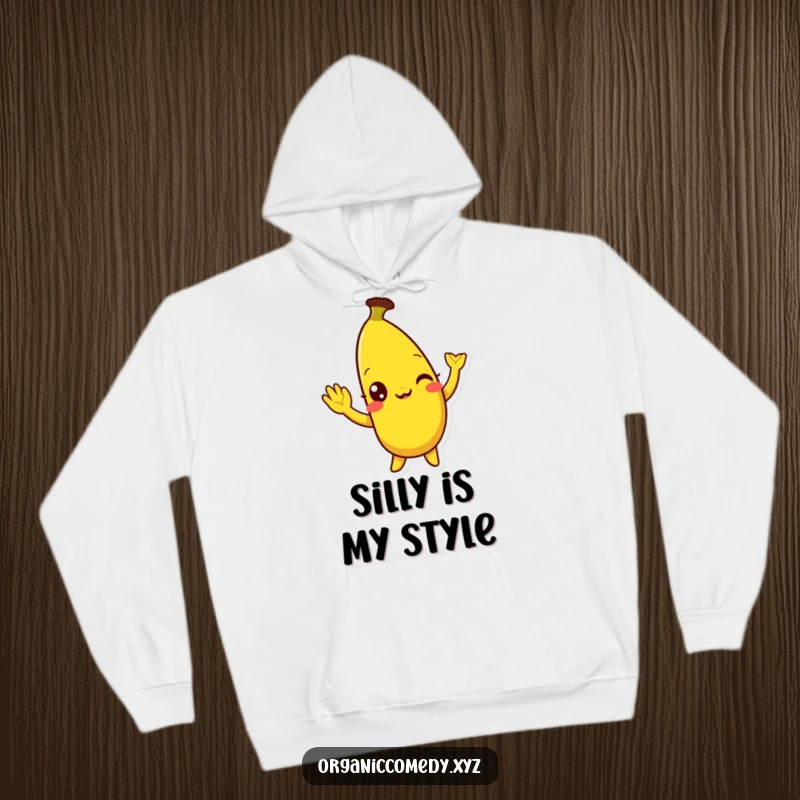 Funny, bright yellow banana character with eyes wide with mirth doing a silly wave, depicted on a soft and warm hoodie.